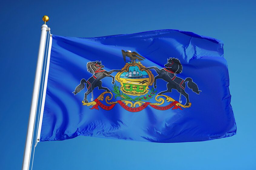 Pennsylvania (U.S. state) flag waving against clear blue sky, close up, isolated with clipping path mask alpha channel transparency, perfect for film, news, composition