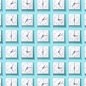 Clocks display various times, arranged in a grid pattern against a teal background.
