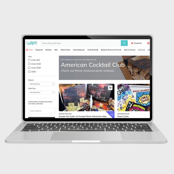 Website displayed on a laptop shows subscription boxes for sale, featuring 
