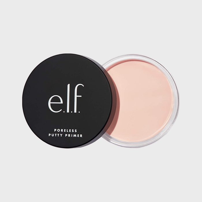 Circular makeup primer container opens, revealing light pink product against a white background. Text on lid: 