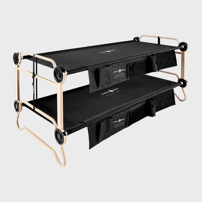 Two-tier collapsible camping cot stacked, featuring tan metal frame with black fabric, in a clean studio setting. Logos 