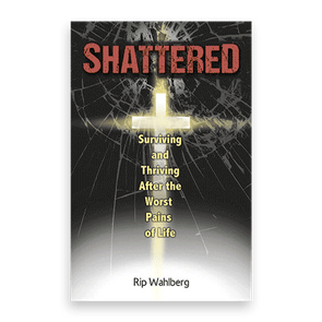A cross illuminates behind shattered glass, emphasizing the text: 