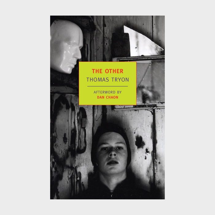 A lifelike mannequin head hangs; a boy looks upward in a worn, wooden room. Text reads: 