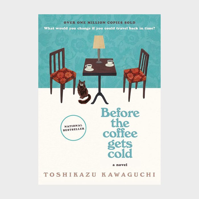 Table holds coffee cups beside a lamp, flanked by chairs. A cat sits nearby. Text: 