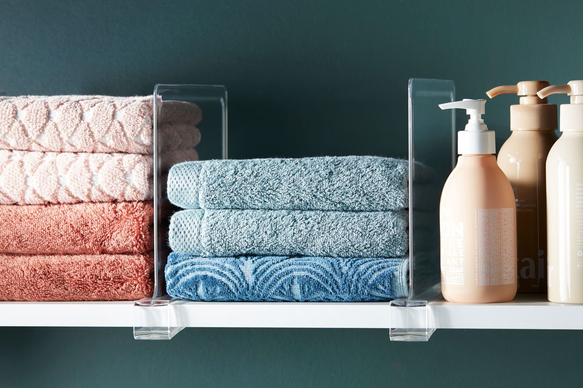 shelf dividers creating division between sections of items on a shelf