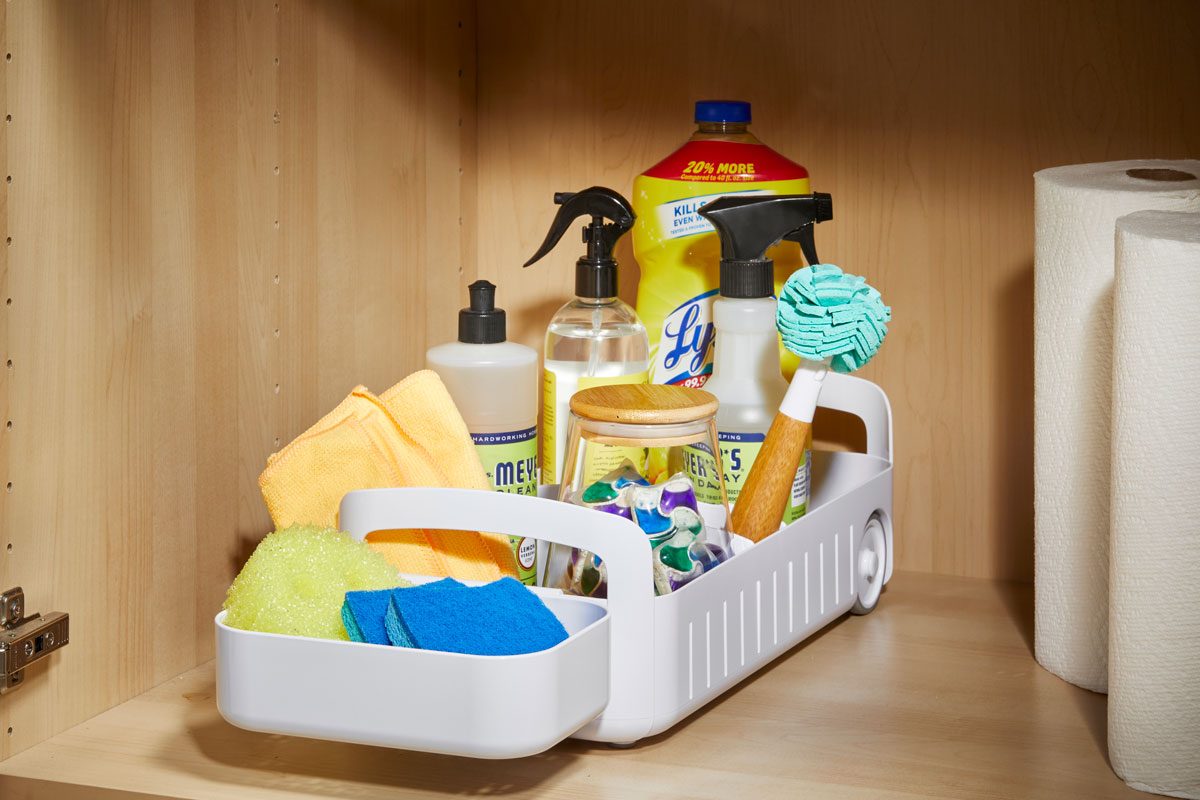 Cleaning supplies organized in a rolling organizer to help easily access deep shelves or cabinets