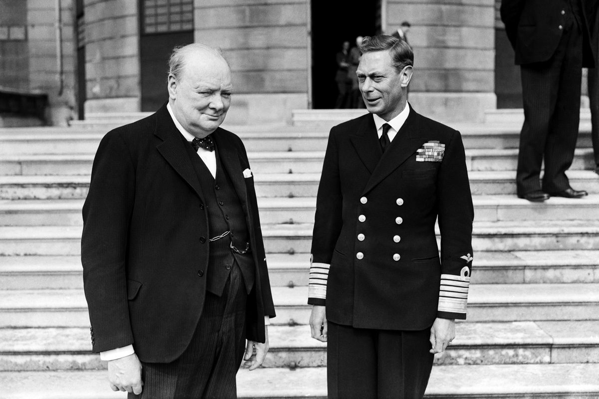 Prime Minister Winston Churchill with King George VI in the grounds of Buckingham Palace