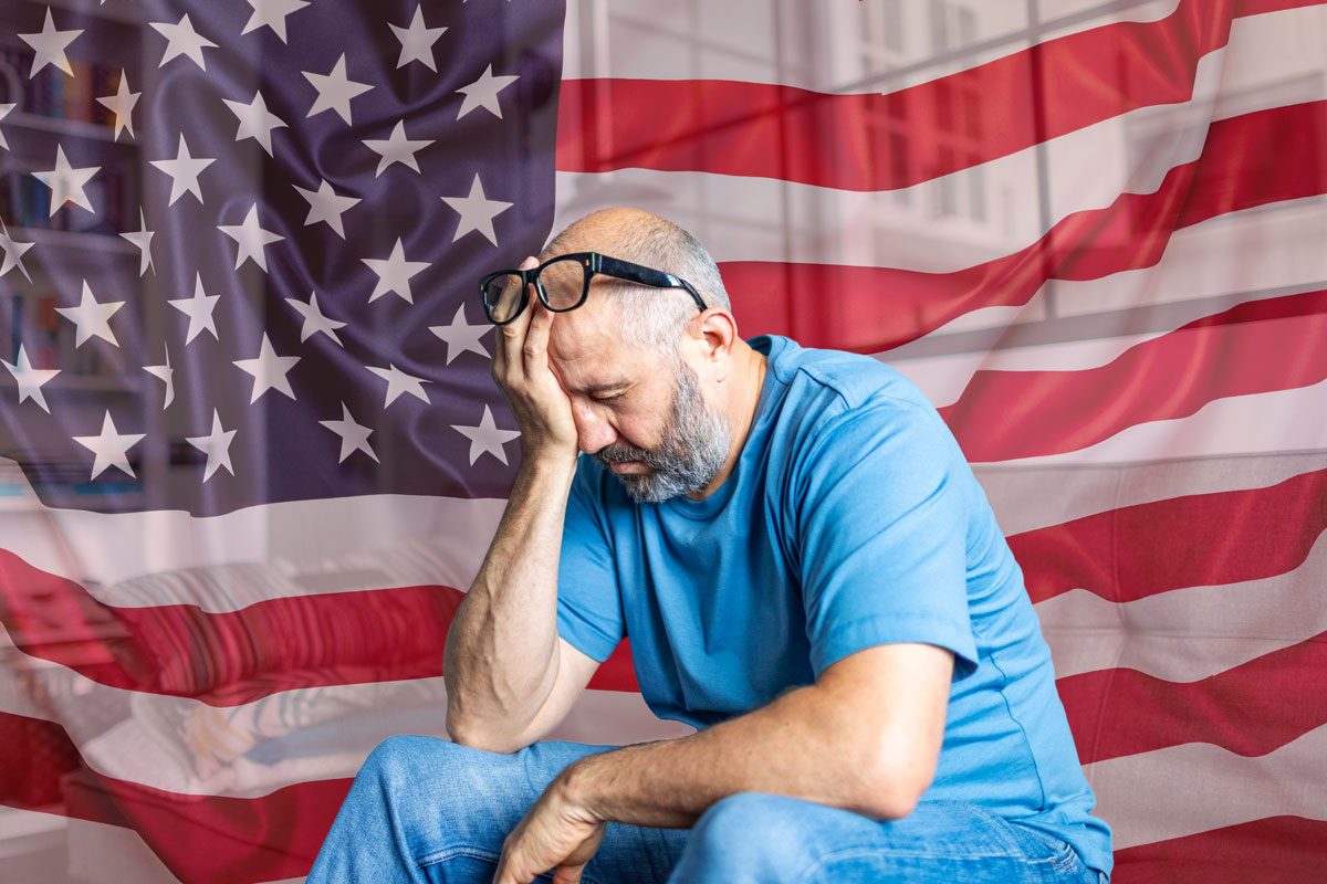 Stressed Man With Us Flag In Background
