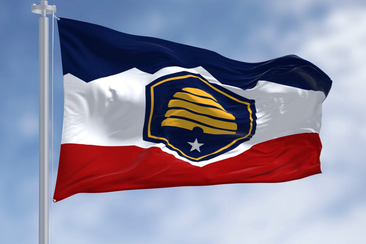 Utah state flag waving on a clear day